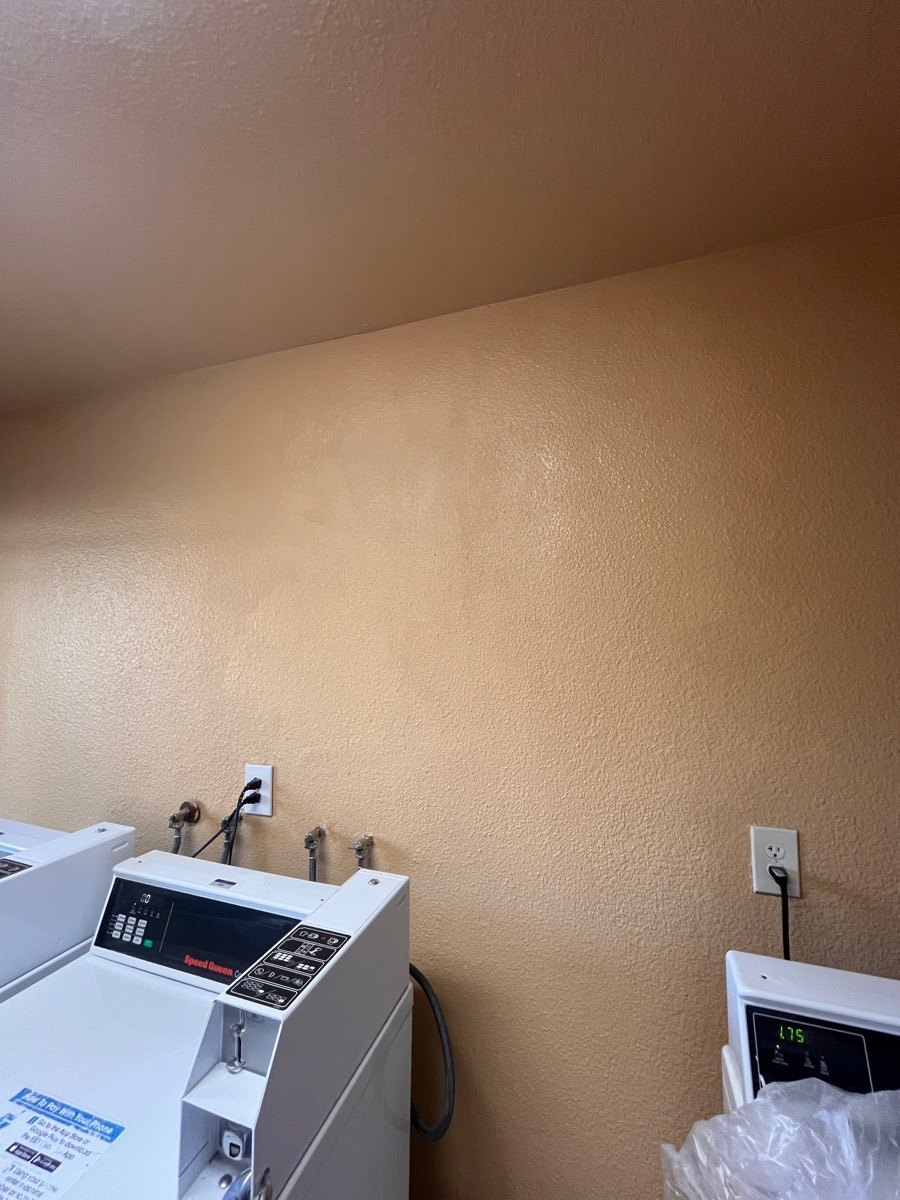 Painted laundry-room wall at the later finish stage.
